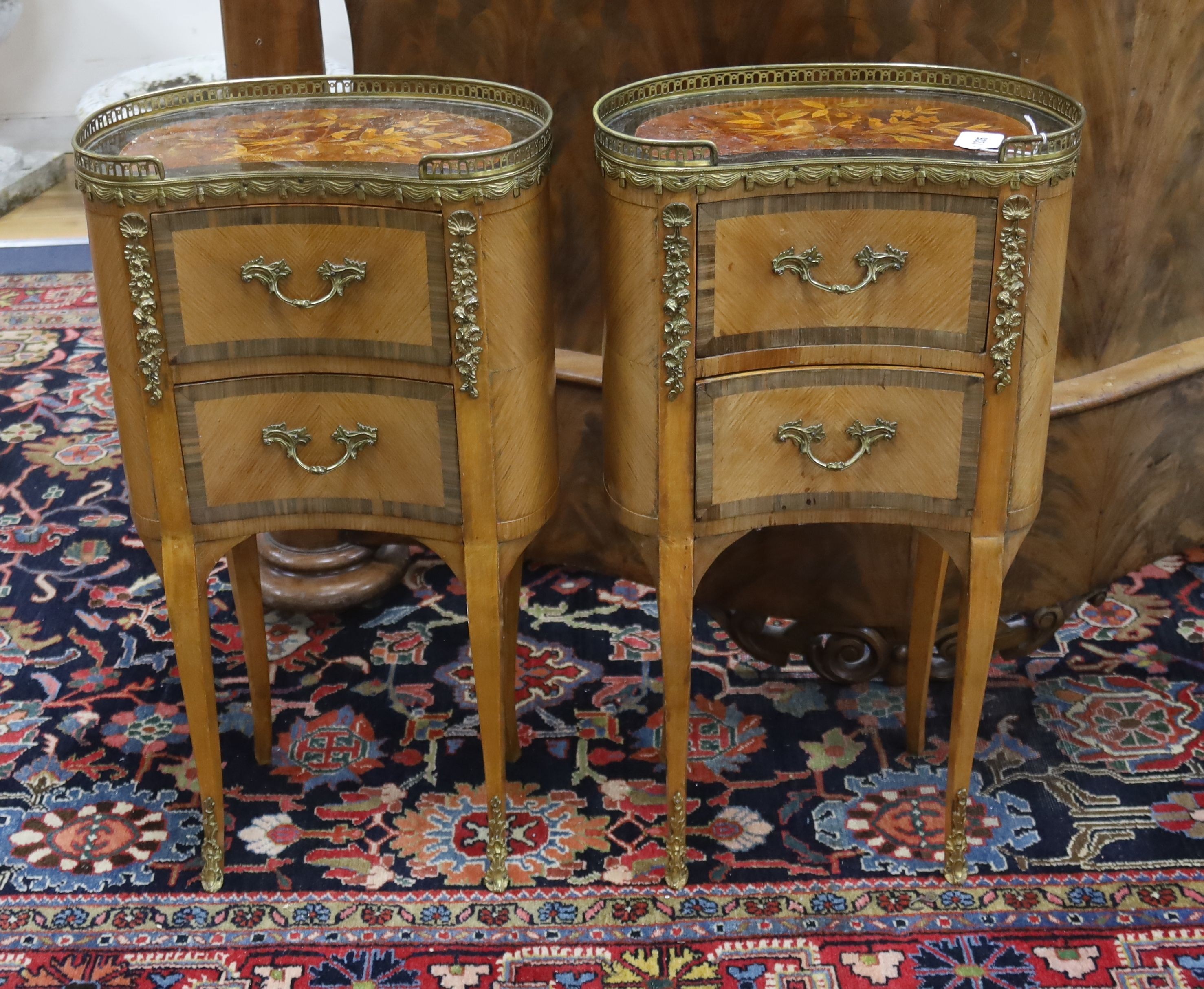 A pair of French marquetry inlaid gilt metal mounted kidney shaped two drawer bedside cabinets, width 42cm, depth 24cm, height 77cm